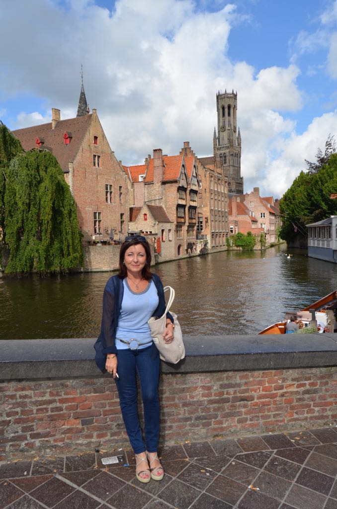 Montse en Brujas junto al muelle del Rosario y torre Belfort al fondo.