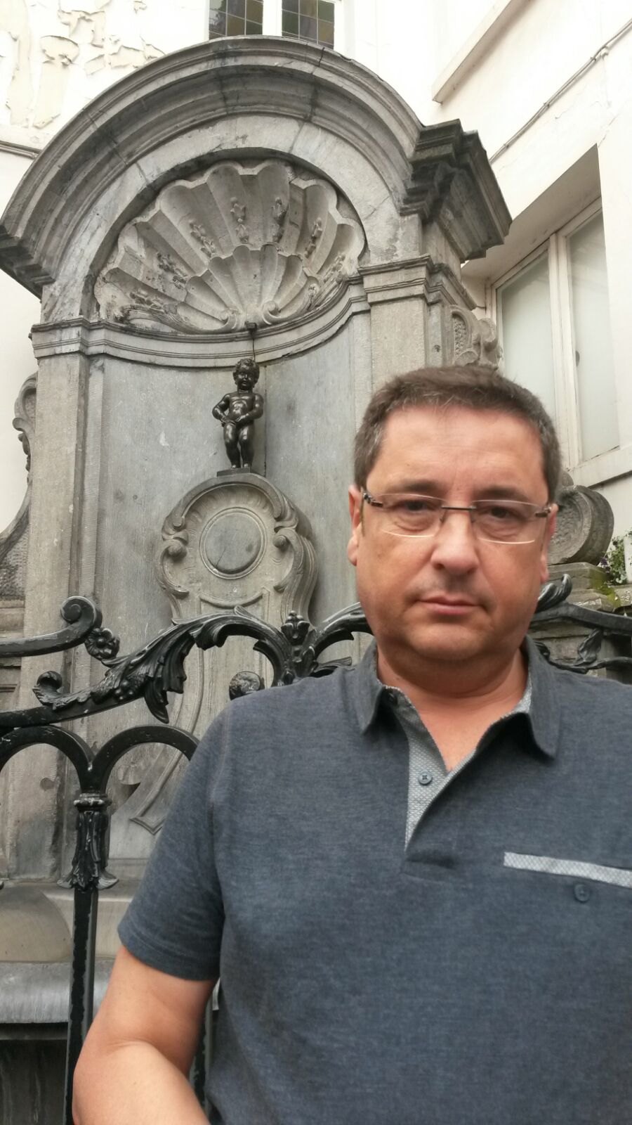 Alfonso junto a la escultura Manneken pis en Bruselas.